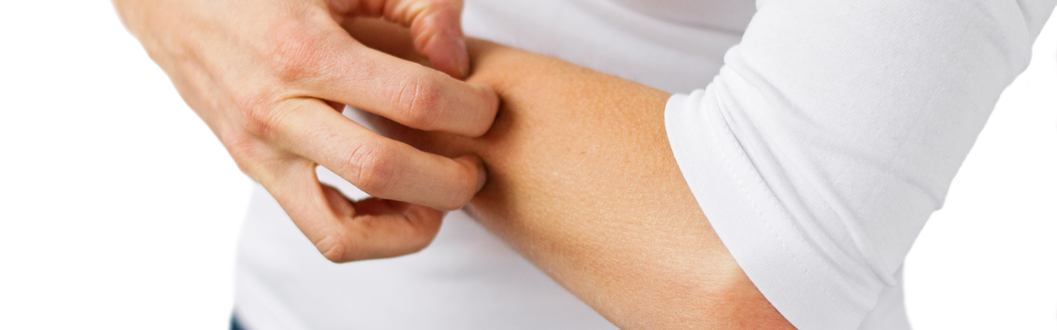 Person scratching their arm, possibly due to skin irritation or allergy